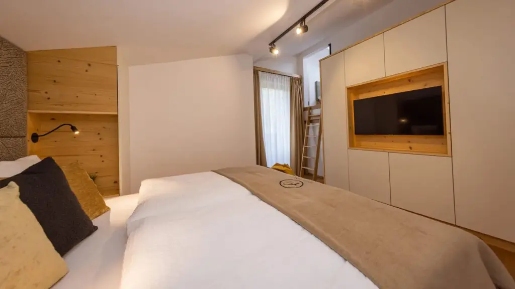 Penthouse bedroom with double bed and smart TV